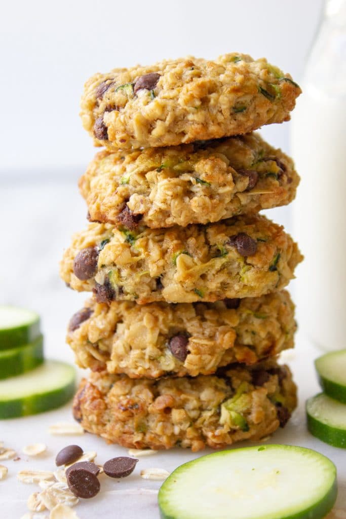 zucchini chocolate chip cookies stacked against a glass of milk