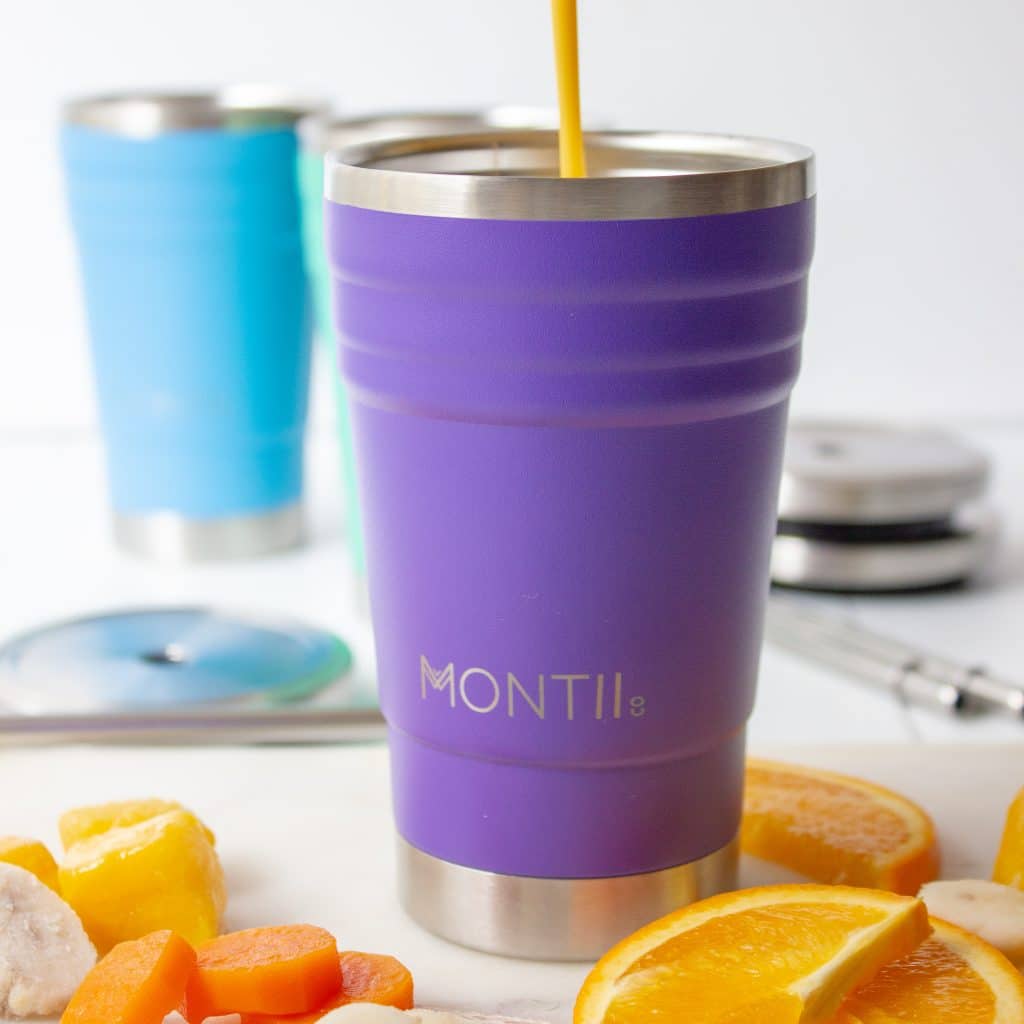 picture of a healthy kids smoothie recipe (mango orange carrot smoothie) being poured into a purple smoothie cup.