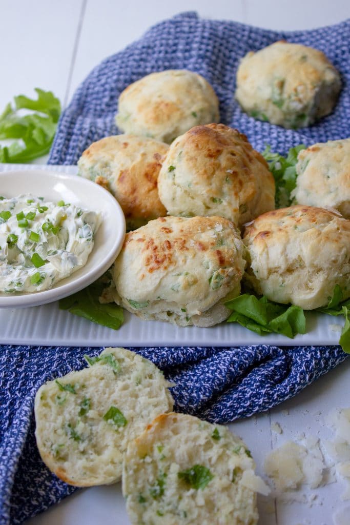 plate of rocket and parmesan scones with a dish of herbed cream cheese