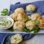 plate of rocket and parmesan scones with a dish of herbed cream cheese