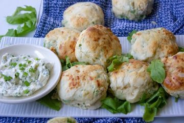 plate of rocket and parmesan scones with a dish of herbed cream cheese