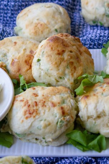 plate of rocket and parmesan scones with a dish of herbed cream cheese