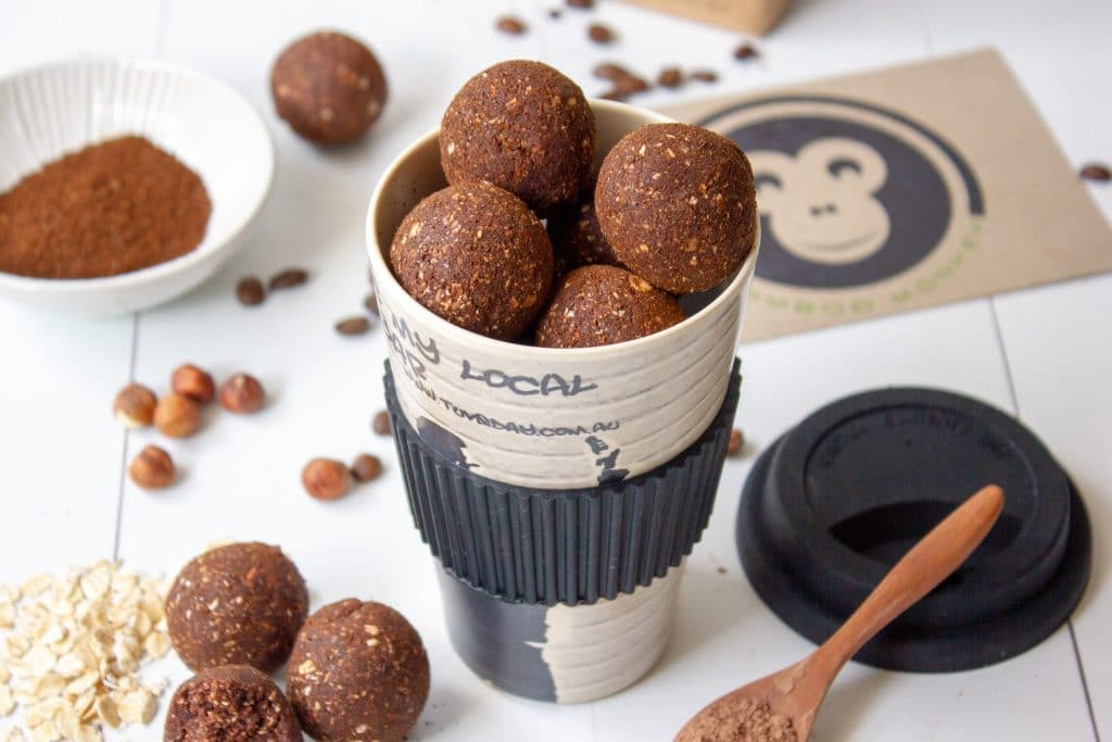 mocha bliss balls in a bamboo reusable coffee cup