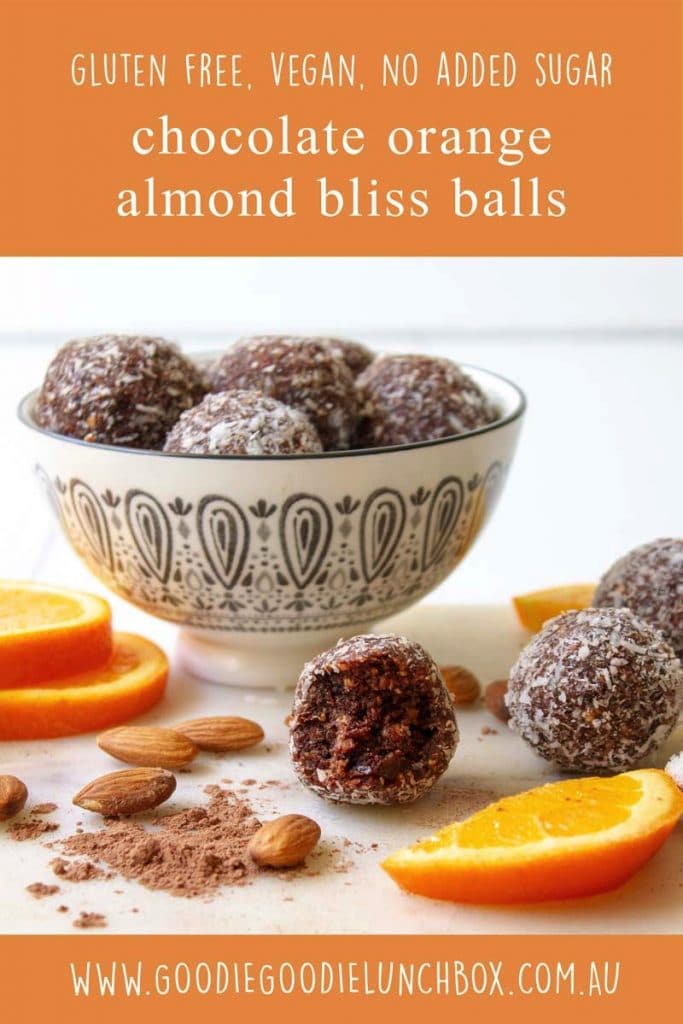 Pinterest image of a bowl of chocolate orange almond bliss balls styled with the ingredients placed around the outside.