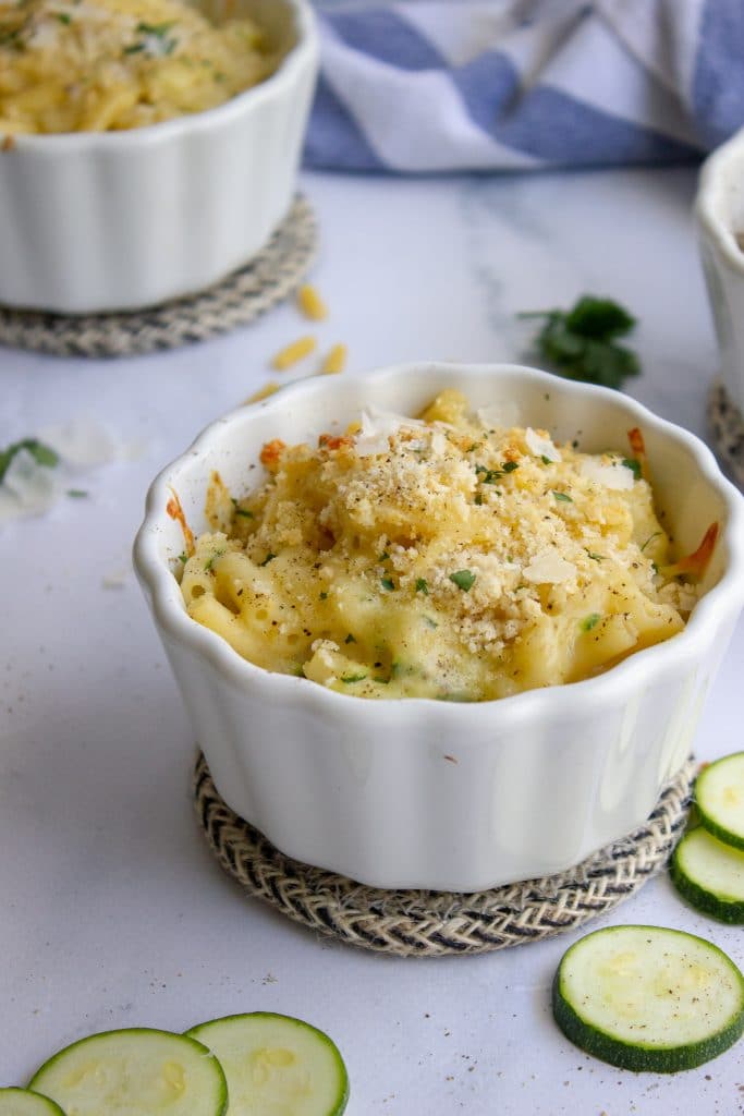 close up picture of zucchini macaroni and cheese in individual ramekins