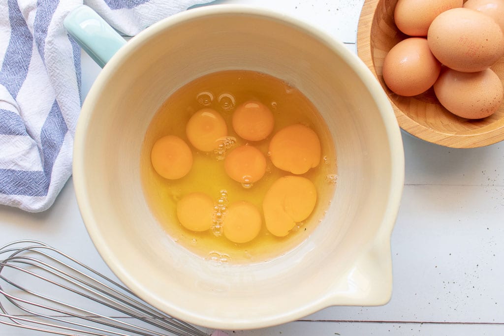 picture of bowl of cracked eggs to make microwave muffin tin frittatas