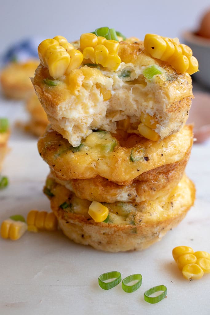 close up of sweet corn and spring onion egg muffin with bite taken out