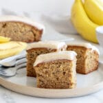Cut banana cake on a plate with forks
