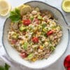 Bowl of Tuna Pasta Salad garnished with parsley.